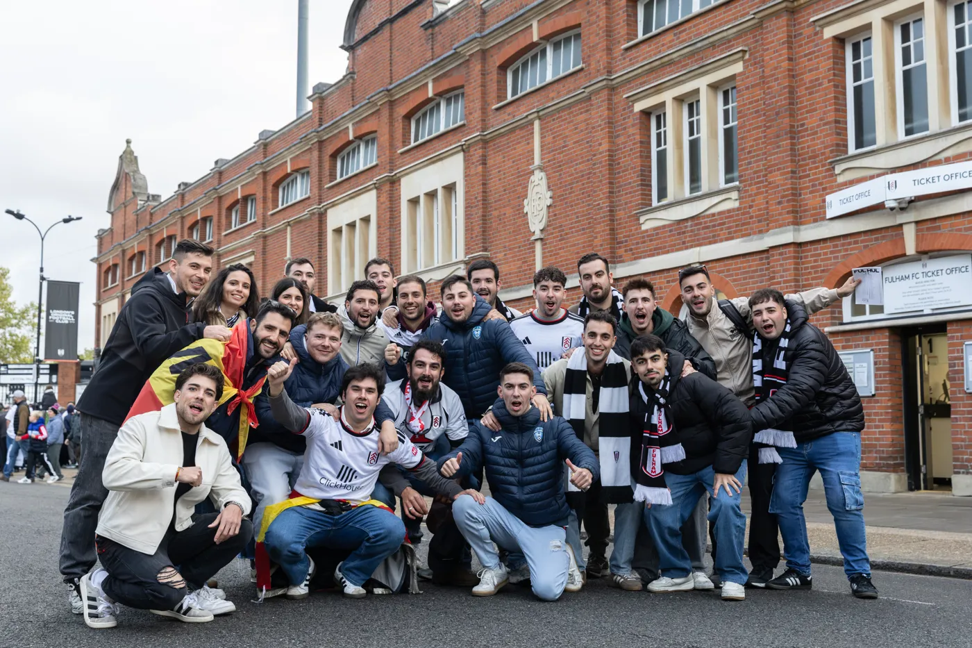 The group posing outside the red-brick frontage of Craven Cottage
