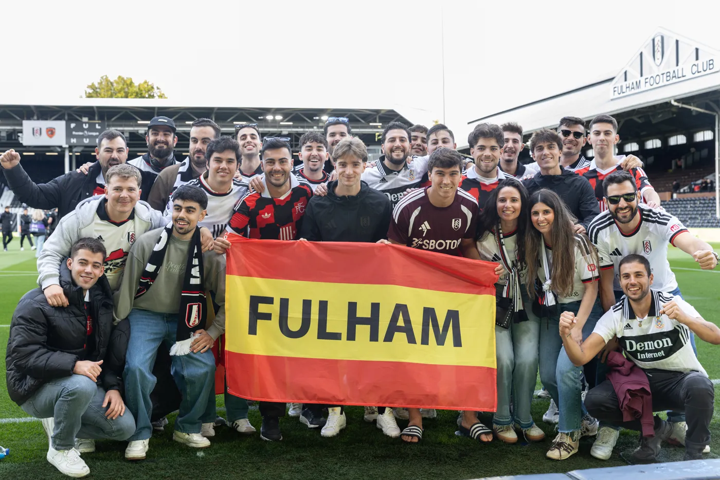 The group from Spain with their Fulham banner on the Craven Cottage pitch