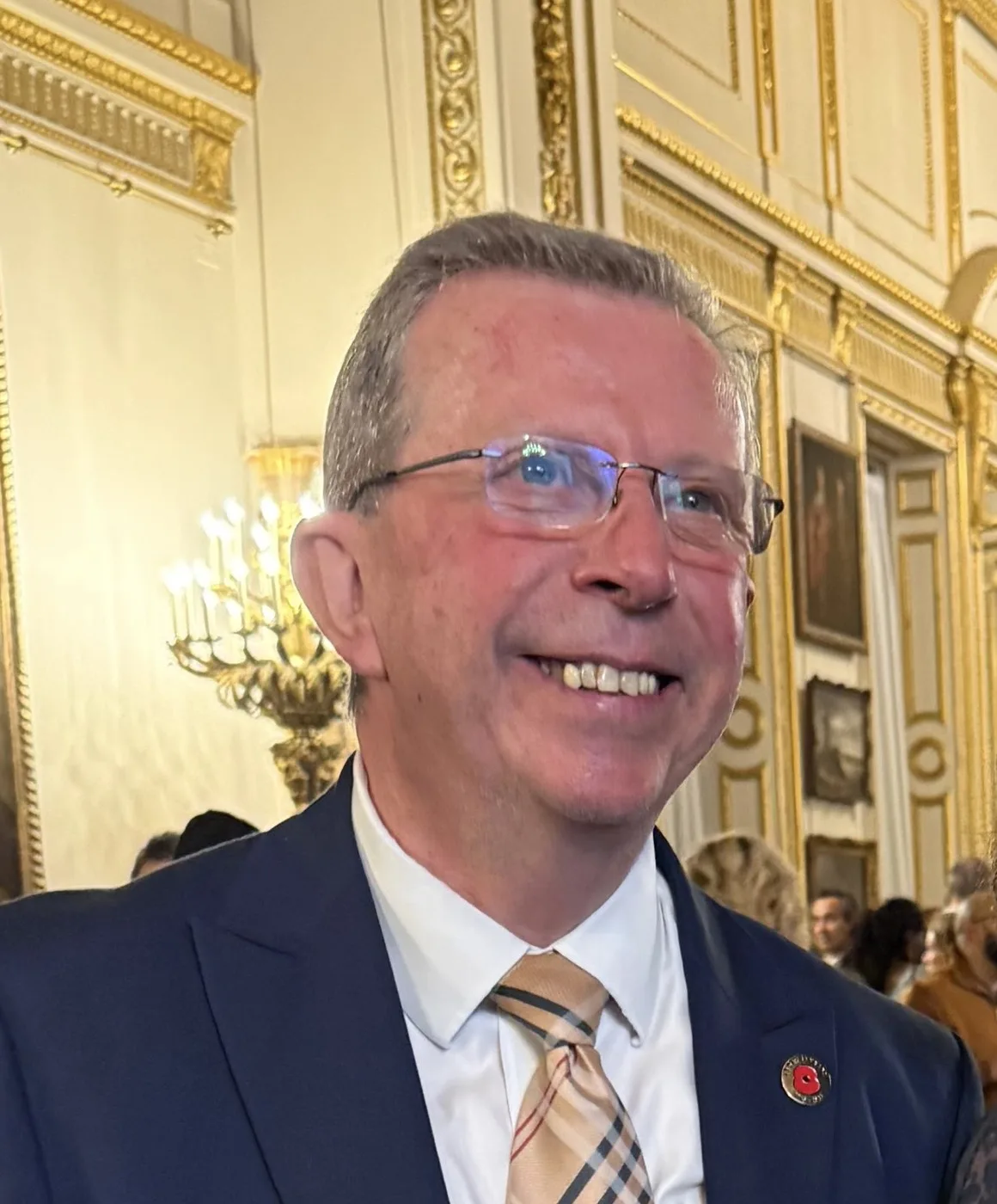Alan Rides, chief executive of West London Chambers of Commerce, smiling in a navy suit and checked tie