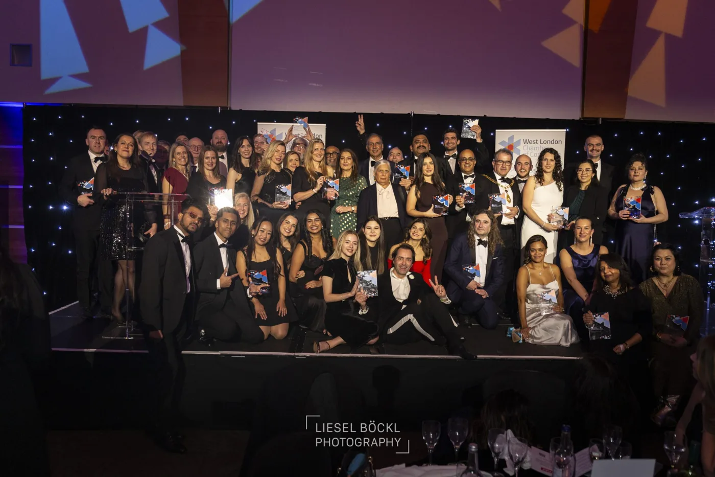 Winners with their trophies on stage at a previous West London Chambers Business Awards